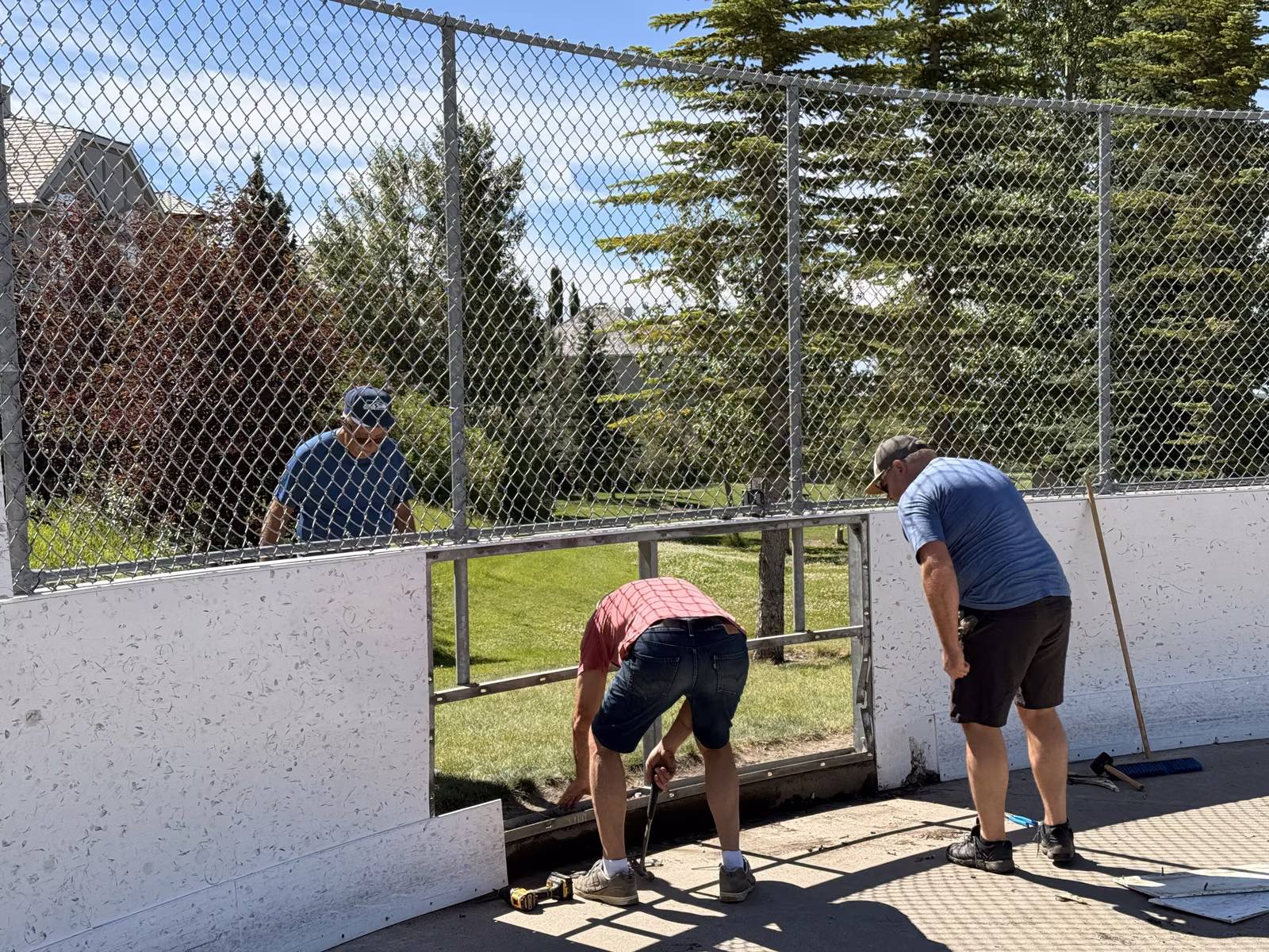 Signal Hill volunteers assembling the outdoor rink boards together on a work day